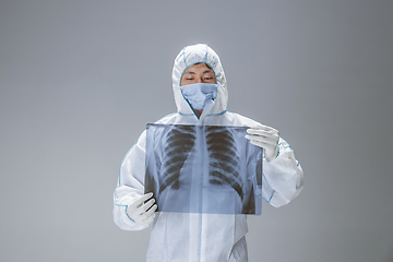 Image showing Medic in white hazmat protective suit, coronavirus illustration concept