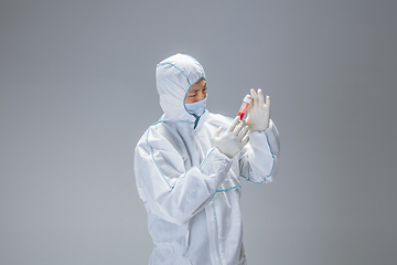 Image showing Medic in white hazmat protective suit, coronavirus illustration concept