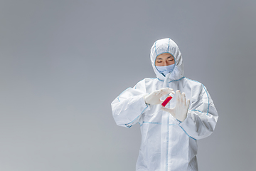 Image showing Medic in white hazmat protective suit, coronavirus illustration concept