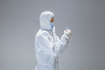 Image showing Medic in white hazmat protective suit, coronavirus illustration concept