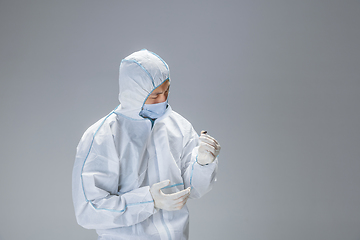 Image showing Medic in white hazmat protective suit, coronavirus illustration concept