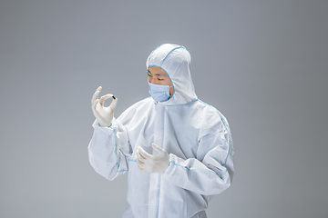 Image showing Medic in white hazmat protective suit, coronavirus illustration concept