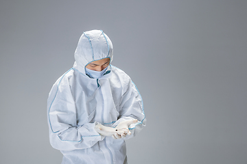 Image showing Medic in white hazmat protective suit, coronavirus illustration concept