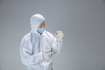 Image showing Medic in white hazmat protective suit, coronavirus illustration concept