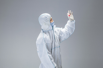 Image showing Medic in white hazmat protective suit, coronavirus illustration concept