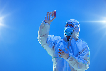 Image showing Medic in white hazmat protective suit, coronavirus illustration concept