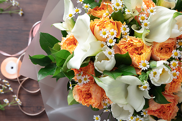 Image showing Close up of fashion modern bouquet of different flowers on wooden background