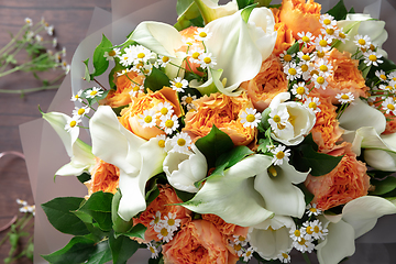 Image showing Close up of fashion modern bouquet of different flowers on wooden background