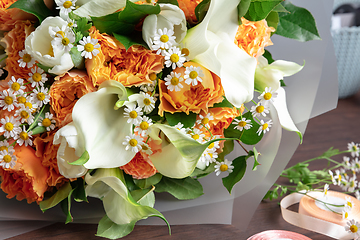 Image showing Close up of fashion modern bouquet of different flowers on wooden background