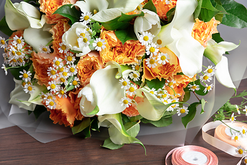 Image showing Close up of fashion modern bouquet of different flowers on wooden background