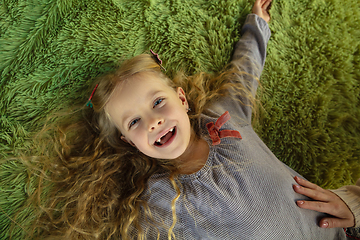 Image showing Happy child, caucasian girl, daughter laying and laughting