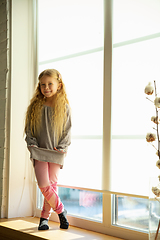 Image showing Happy child, caucasian girl, daughter posing against window