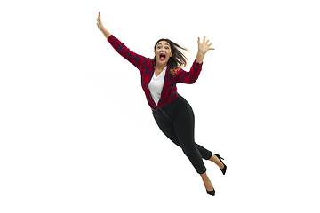 Image showing A second before falling - young girl falling down with bright emotions and expression