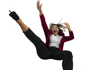 Image showing A second before falling - young girl falling down with bright emotions and expression