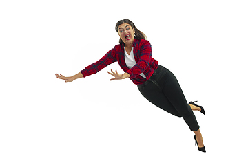 Image showing A second before falling - young girl falling down with bright emotions and expression