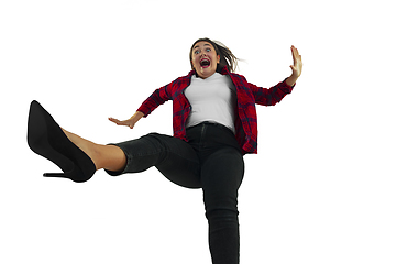 Image showing A second before falling - young girl falling down with bright emotions and expression