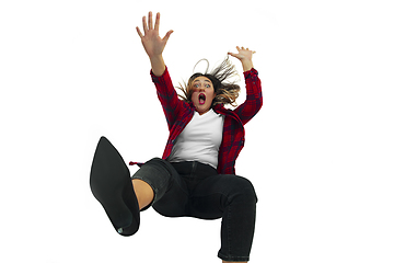 Image showing A second before falling - young girl falling down with bright emotions and expression