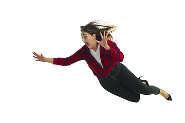 Image showing A second before falling - young girl falling down with bright emotions and expression