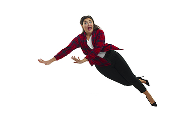 Image showing A second before falling - young girl falling down with bright emotions and expression