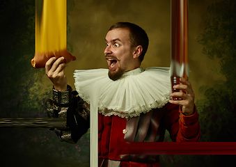 Image showing Young man as a medieval knight on dark background, stylish creative design