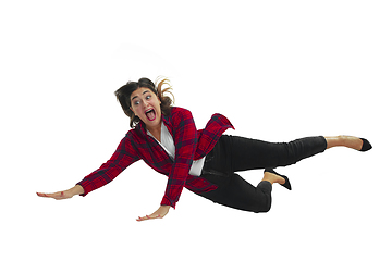 Image showing A second before falling - young girl falling down with bright emotions and expression