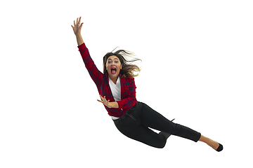 Image showing A second before falling - young girl falling down with bright emotions and expression