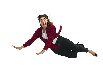 Image showing A second before falling - young girl falling down with bright emotions and expression