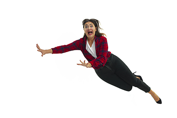 Image showing A second before falling - young girl falling down with bright emotions and expression