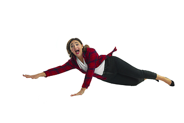 Image showing A second before falling - young girl falling down with bright emotions and expression