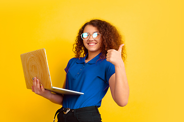 Image showing Caucasian teen\'s girl portrait on yellow background