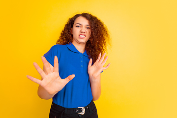 Image showing Caucasian teen\'s girl portrait on yellow background