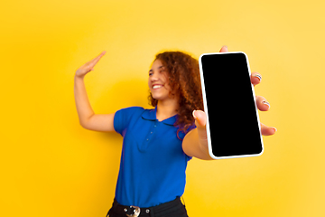 Image showing Caucasian teen\'s girl portrait on yellow background