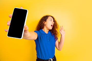 Image showing Caucasian teen\'s girl portrait on yellow background