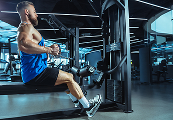 Image showing The male athlete training hard in the gym. Fitness and healthy life concept.