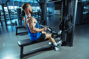 Image showing The male athlete training hard in the gym. Fitness and healthy life concept.