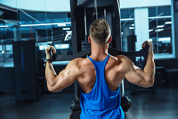 Image showing The male athlete training hard in the gym. Fitness and healthy life concept.