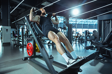 Image showing The male athlete training hard in the gym. Fitness and healthy life concept.