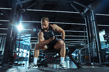 Image showing The male athlete training hard in the gym. Fitness and healthy life concept.