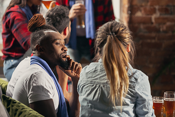 Image showing Excited group of people watching football, sport match at home