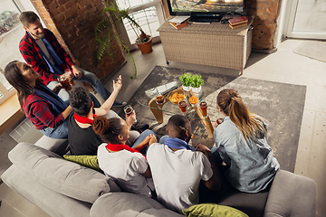 Image showing Excited group of people watching sport match at home