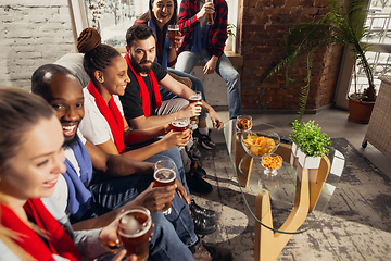 Image showing Excited group of people watching football, sport match at home