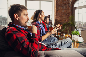 Image showing Excited group of people watching football, sport match at home