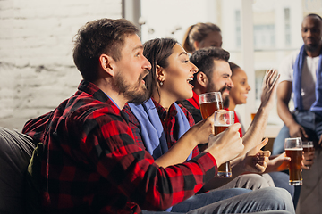 Image showing Excited group of people watching football, sport match at home