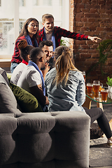 Image showing Excited group of people watching football, sport match at home