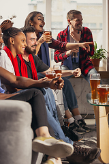 Image showing Excited group of people watching football, sport match at home