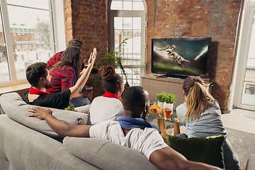 Image showing Excited group of people watching sport match at home