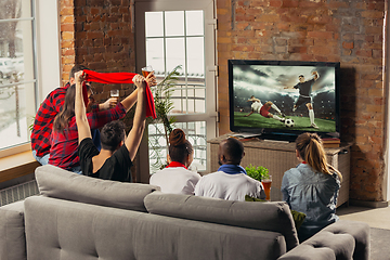 Image showing Excited group of people watching sport match at home