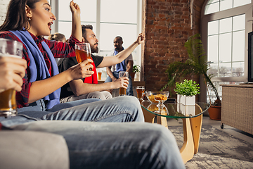 Image showing Excited group of people watching football, sport match at home