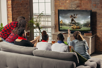 Image showing Excited group of people watching sport match at home