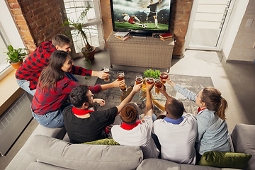 Image showing Excited group of people watching sport match at home